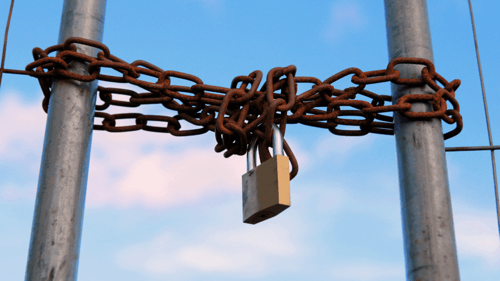  A chain and padlock attached to a pole, illustrating the concept of limiting subconscious beliefs.