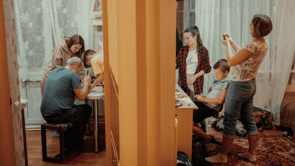 A family gathers at a table in a warm room, reflecting on how indecisiveness affects their everyday choices.